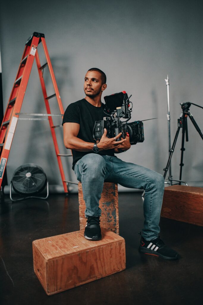 studio portrait of a many holding a film or TV production camera